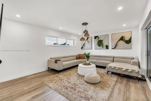 a living room with furniture and wall paintings
