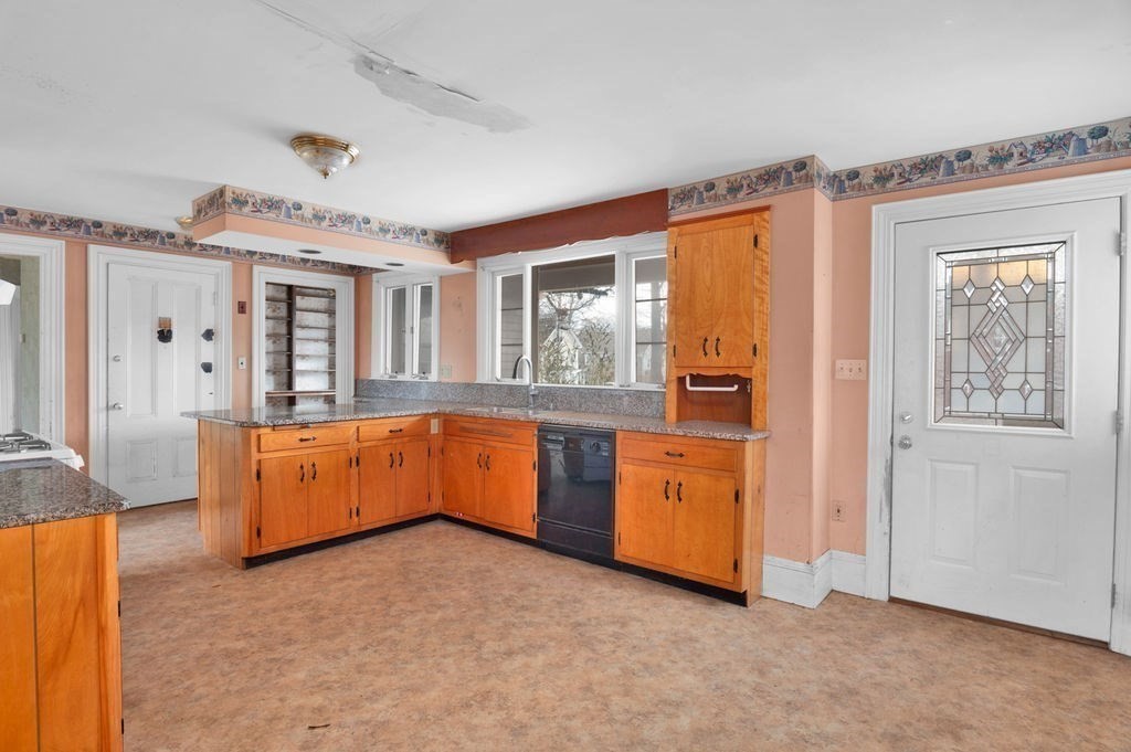 37 School Street Merrimac, MA 01860 - Photo 6 of 34 a large kitchen with a large window and stainless steel appliances