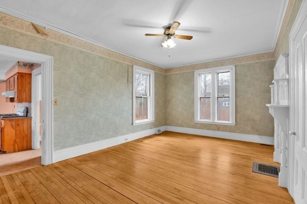 37 School Street Merrimac, MA 01860 - Photo 8 of 34 an empty room with wooden floor chandelier fan and windows