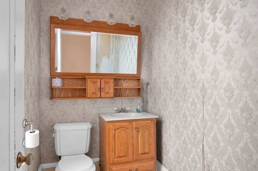 37 School Street Merrimac, MA 01860 - Photo 9 of 34 a bathroom with a toilet sink and mirror