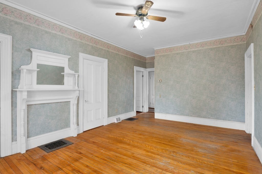 37 School Street Merrimac, MA 01860 - Photo 10 of 34 a view of empty room with wooden floor and fireplace