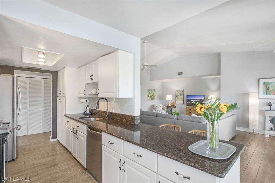 1447 Albatross Road Sanibel, FL 33957 - Photo 11 of 29 a kitchen with stainless steel appliances granite countertop a sink a counter space and cabinets