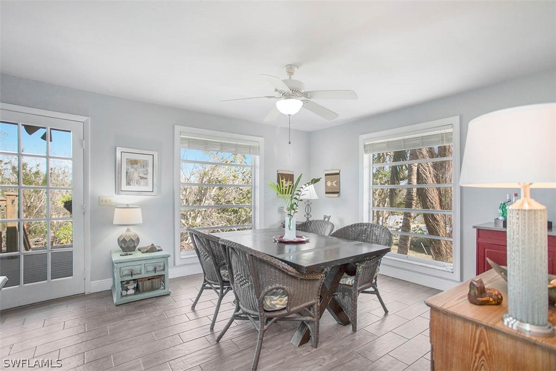 1447 Albatross Road Sanibel, FL 33957 - Photo 12 of 29 a dining room with furniture and wooden floor