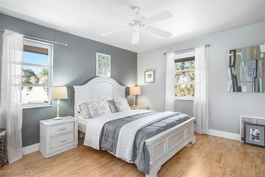 1447 Albatross Road Sanibel, FL 33957 - Photo 13 of 29 a bedroom with a large bed and a chandelier