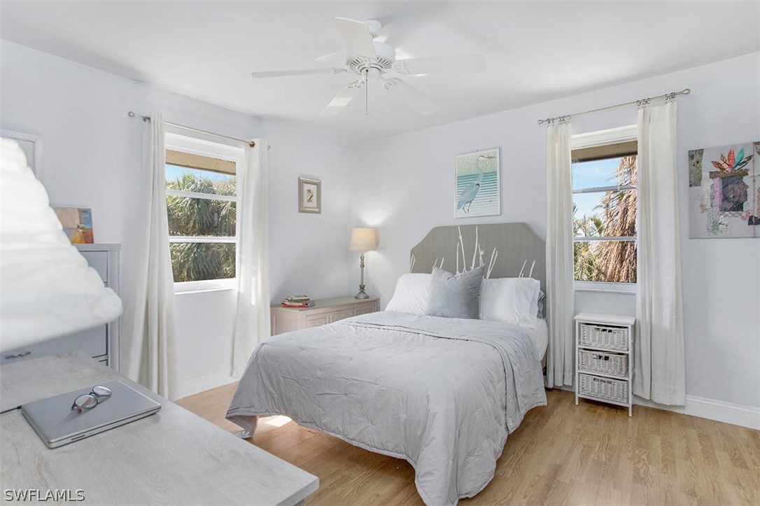1447 Albatross Road Sanibel, FL 33957 - Photo 16 of 29 a bedroom with a bed and a window