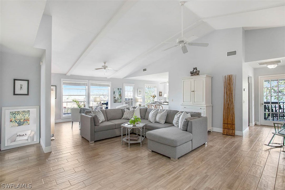1447 Albatross Road Sanibel, FL 33957 - Photo 3 of 29 a living room with furniture and a wooden floor