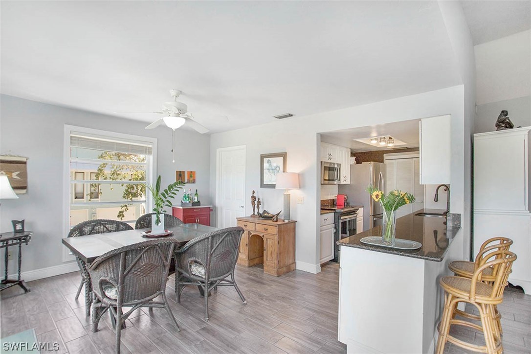 1447 Albatross Road Sanibel, FL 33957 - Photo 10 of 29 a view of a dining room with furniture and wooden floor