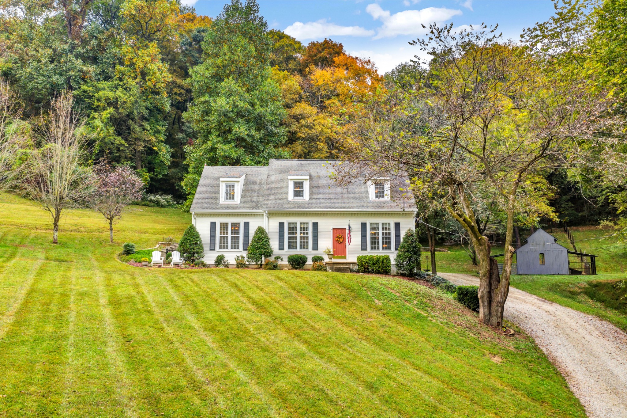 a front view of a house with a big yard