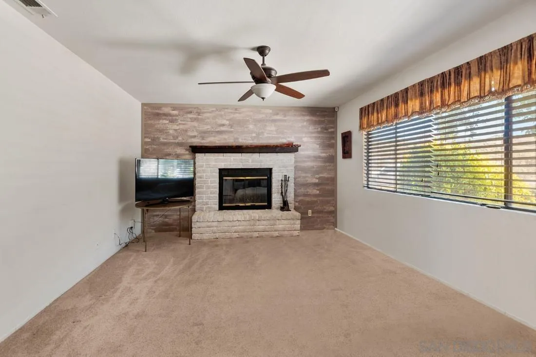 288 Peutz Valley Road Alpine, CA 91901 - Photo 12 of 68 a view of an empty room with a fireplace and a window