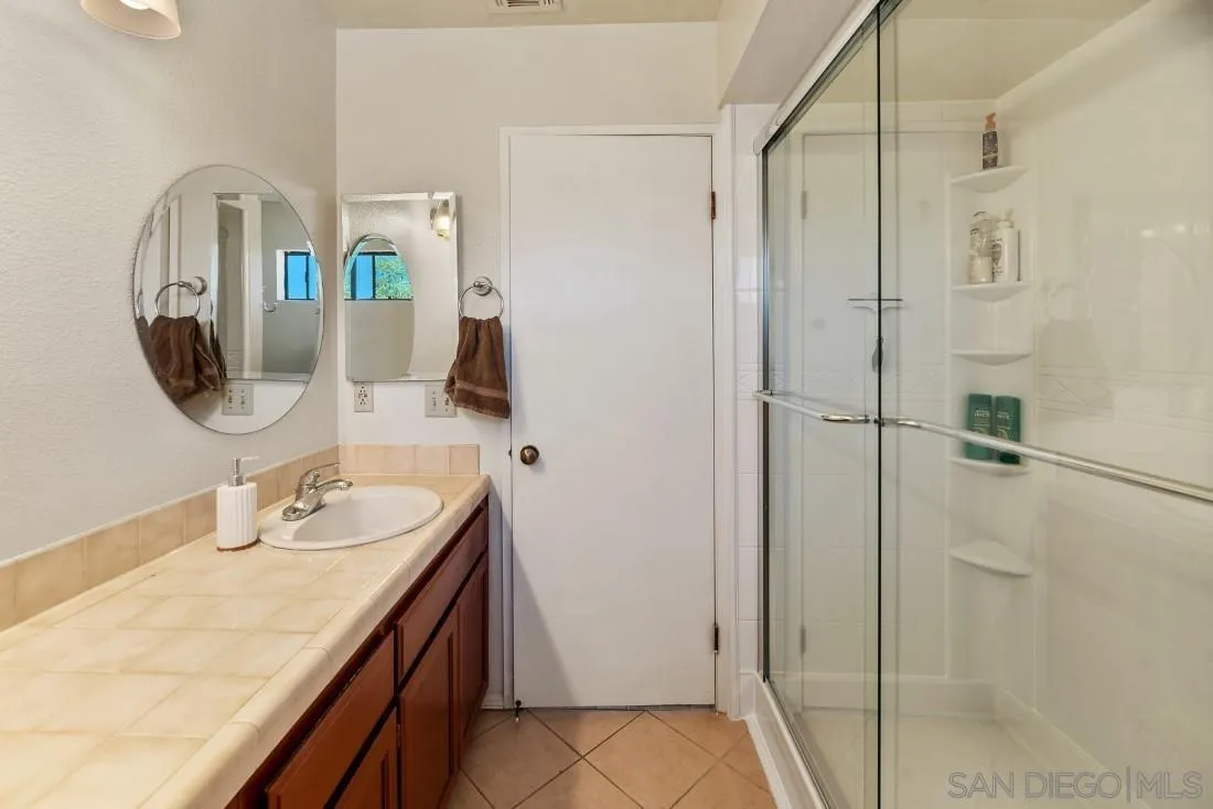 288 Peutz Valley Road Alpine, CA 91901 - Photo 31 of 68 a bathroom with a sink vanity granite shower and a mirror