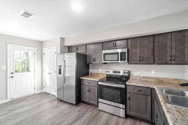 a kitchen with stainless steel appliances a refrigerator stove and sink