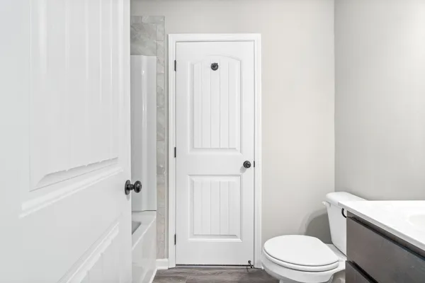 a bathroom with a toilet a sink and shower
