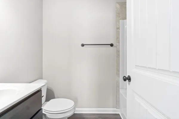 a white toilet and a shower curtain