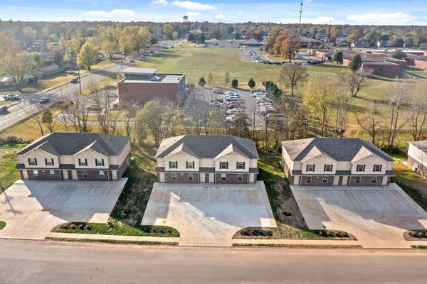 an aerial view of residential houses with city view