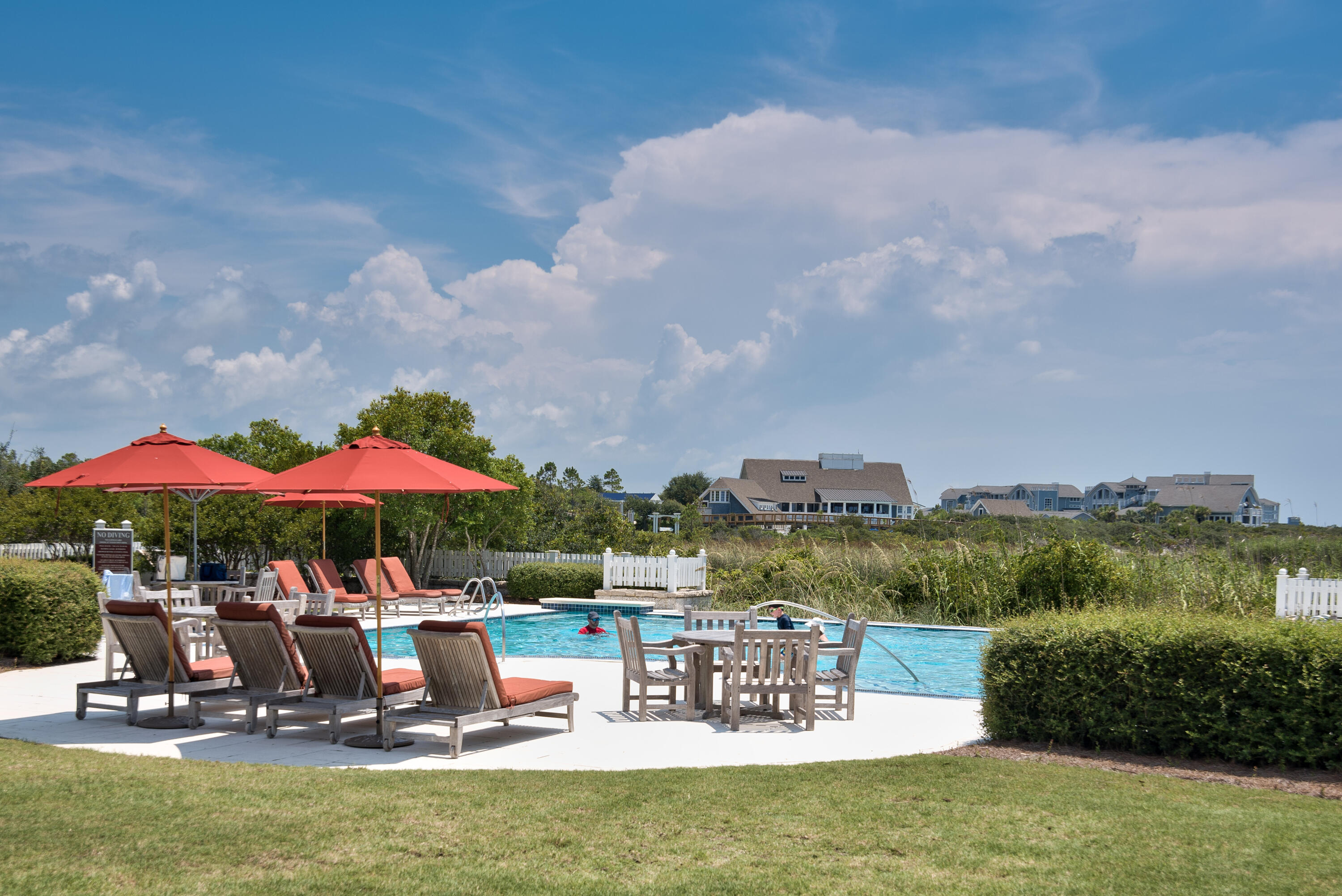 37 Compass Point Way South, Unit 108 Inlet Beach, FL 32461 - Photo 44 of 65 a view of a swimming pool with lawn chairs under an umbrella