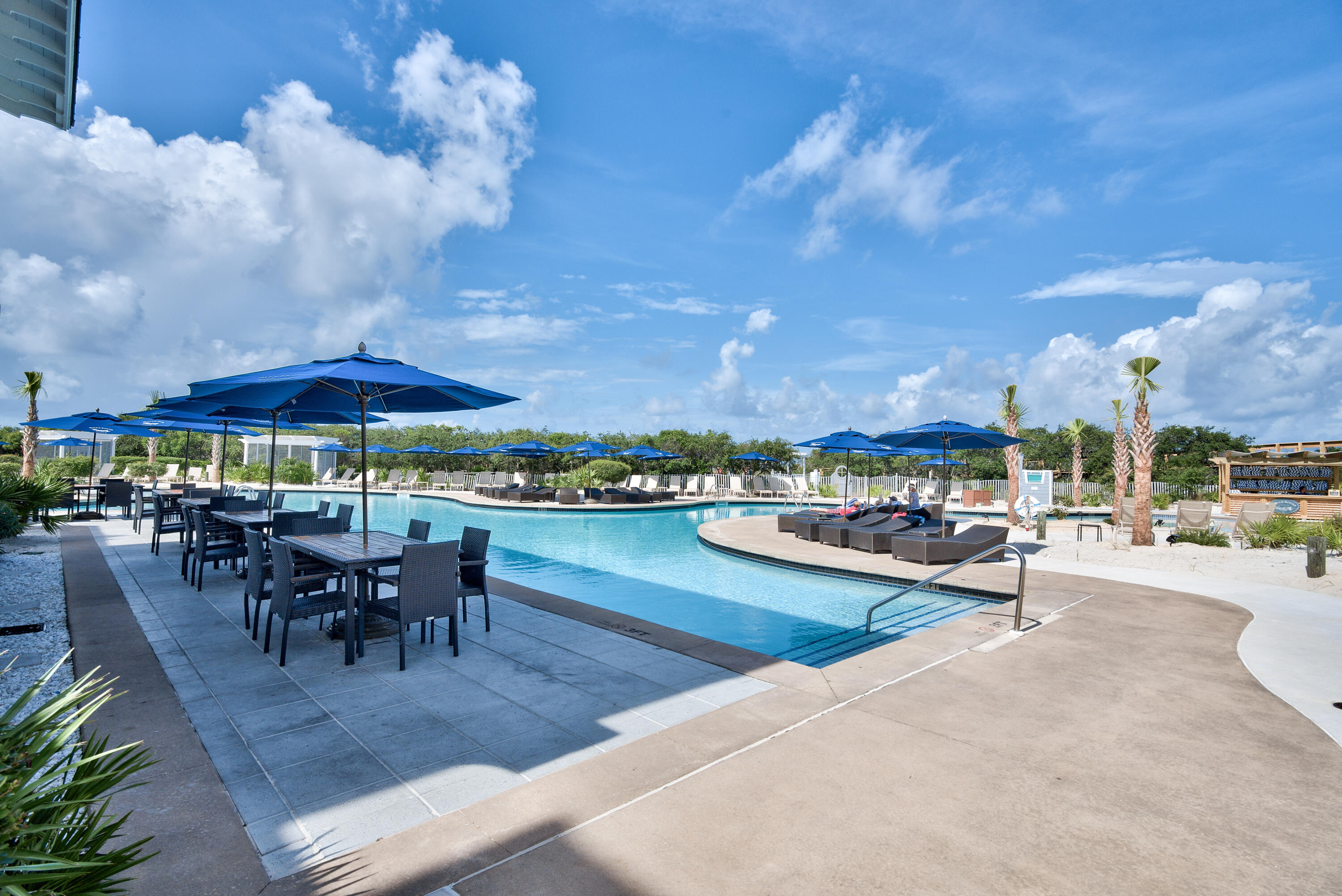 37 Compass Point Way South, Unit 108 Inlet Beach, FL 32461 - Photo 55 of 65 a view of a patio with dining table and chairs under an umbrella