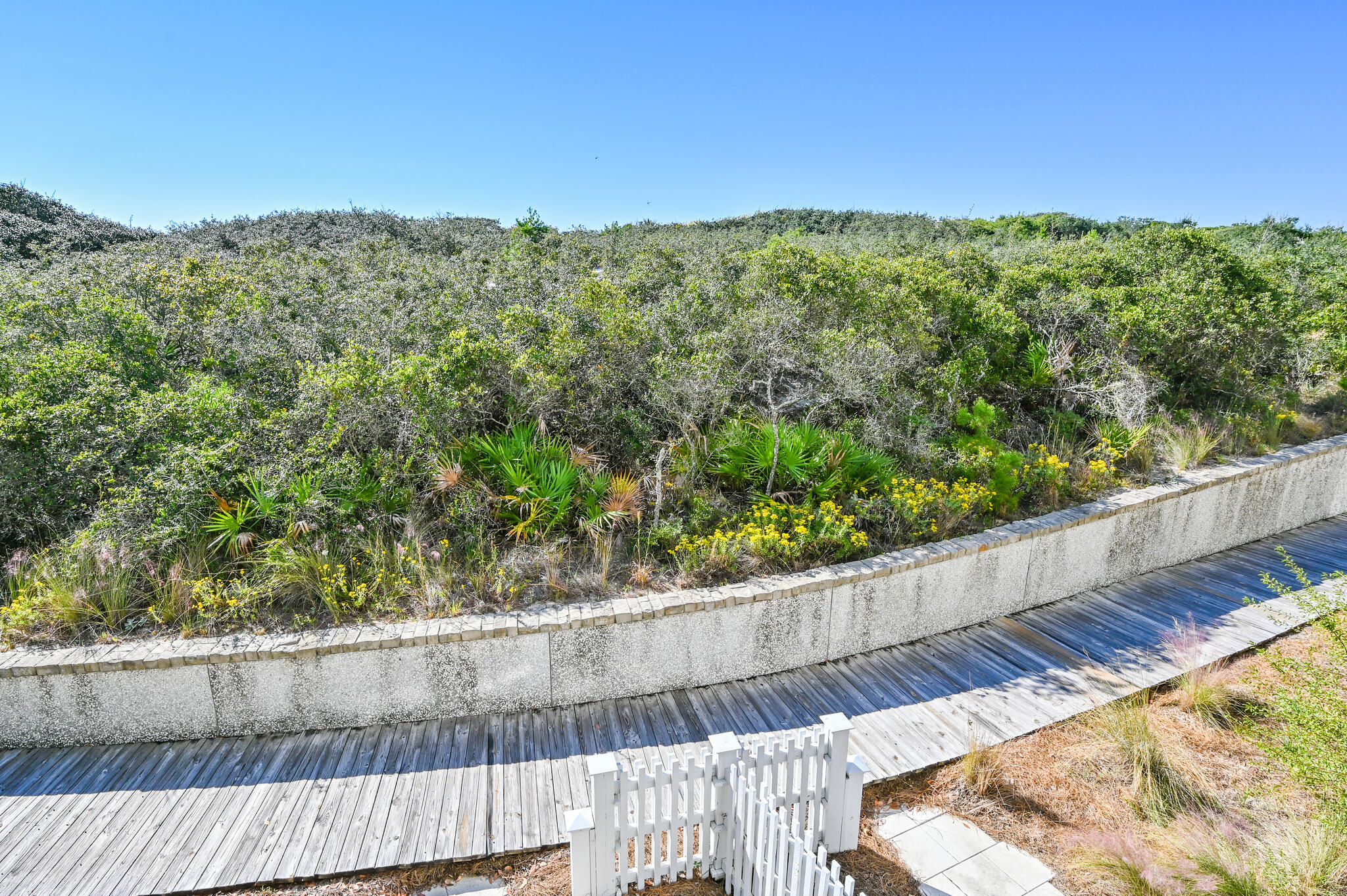 37 Compass Point Way South, Unit 108 Inlet Beach, FL 32461 - Photo 60 of 65 a view of a wooden fence from a balcony
