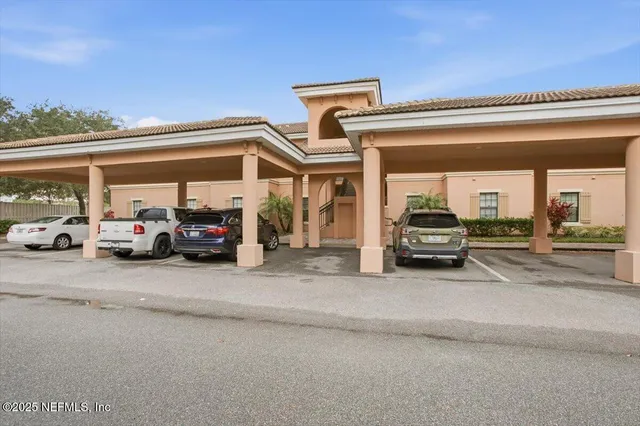a view of a cars park in front of building