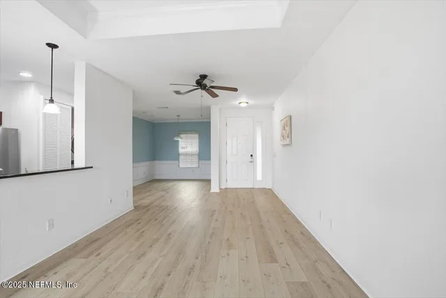 a view of a room with wooden floor and windows