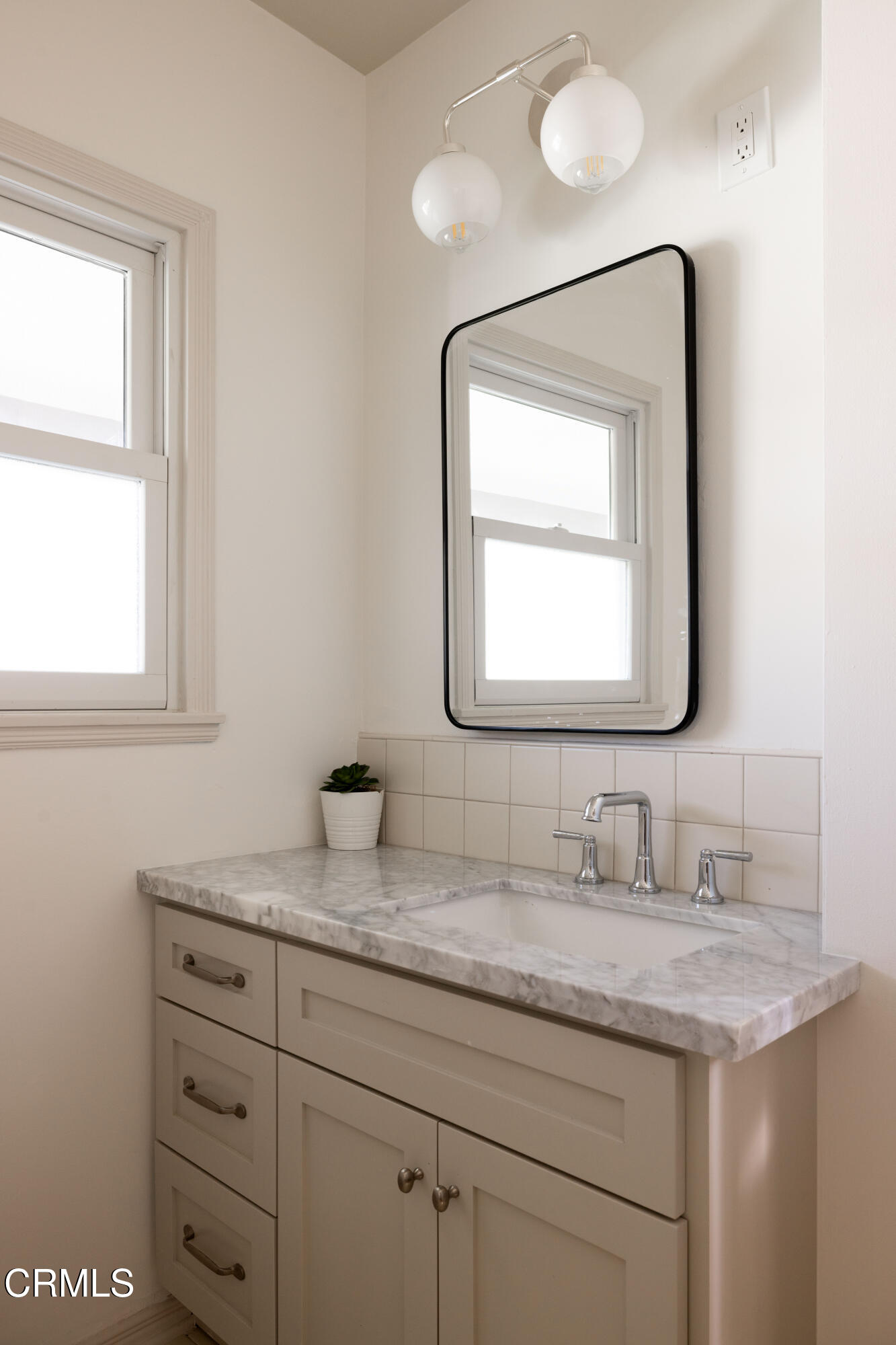 960 Roxbury Drive Pasadena, CA 91104 - Photo 19 of 28 a bathroom with a granite countertop sink a large mirror and a window