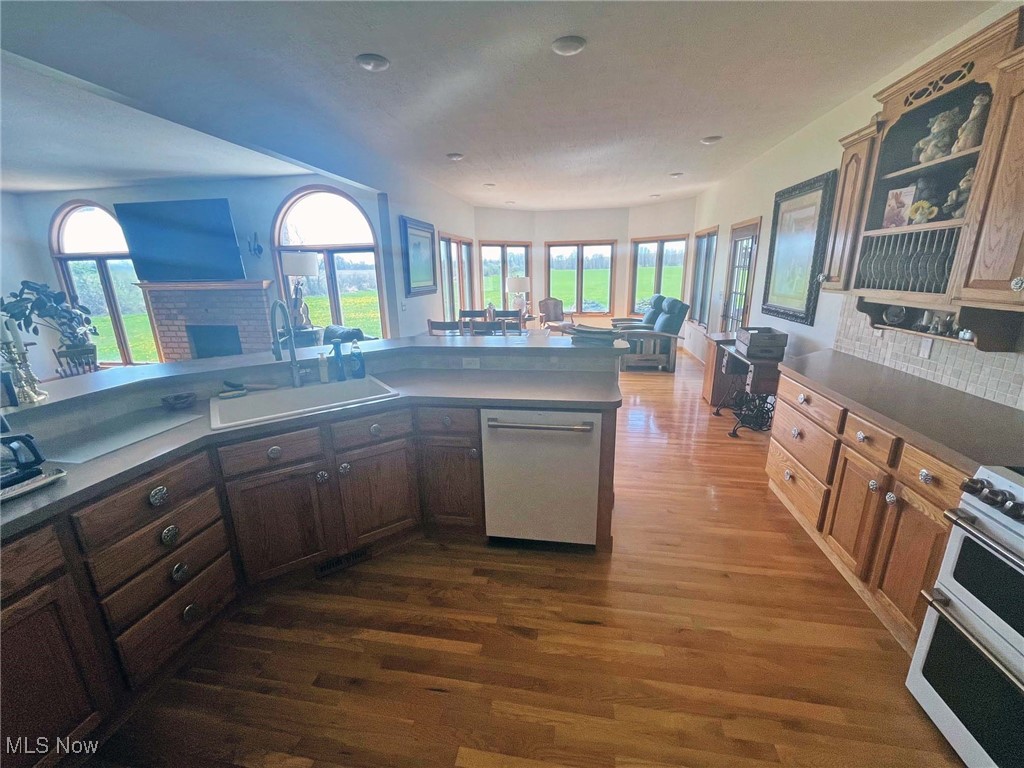 2159 Alliance Road Deerfield, OH 44411 - Photo 33 of 33 Kitchen featuring a sink, open floor plan, dishwasher, range, and dark wood-style flooring