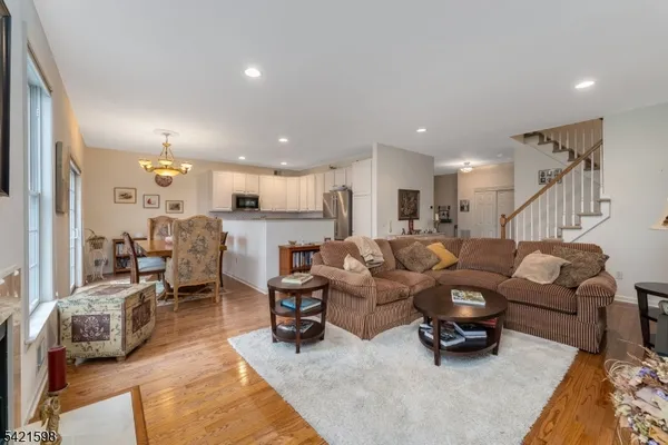 a living room with lots of furniture and a chandelier