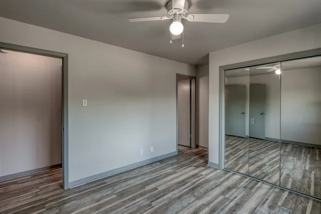 a view of an empty room with wooden floor