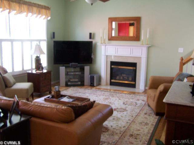 1001 Goswick Ridge Road Midlothian, VA 23114 - Photo 6 of 10 a living room with furniture a flat screen tv and a fireplace