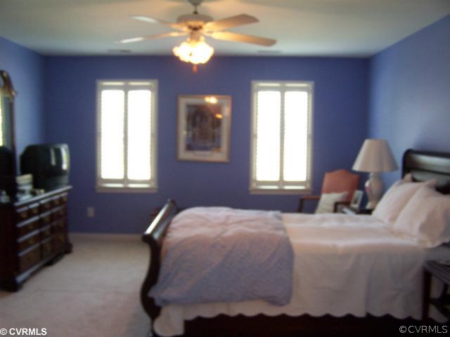 1001 Goswick Ridge Road Midlothian, VA 23114 - Photo 7 of 10 a bedroom with a bed and wooden floor