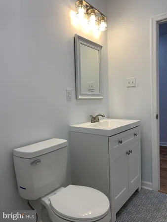 a white toilet sitting next to a bathroom sink
