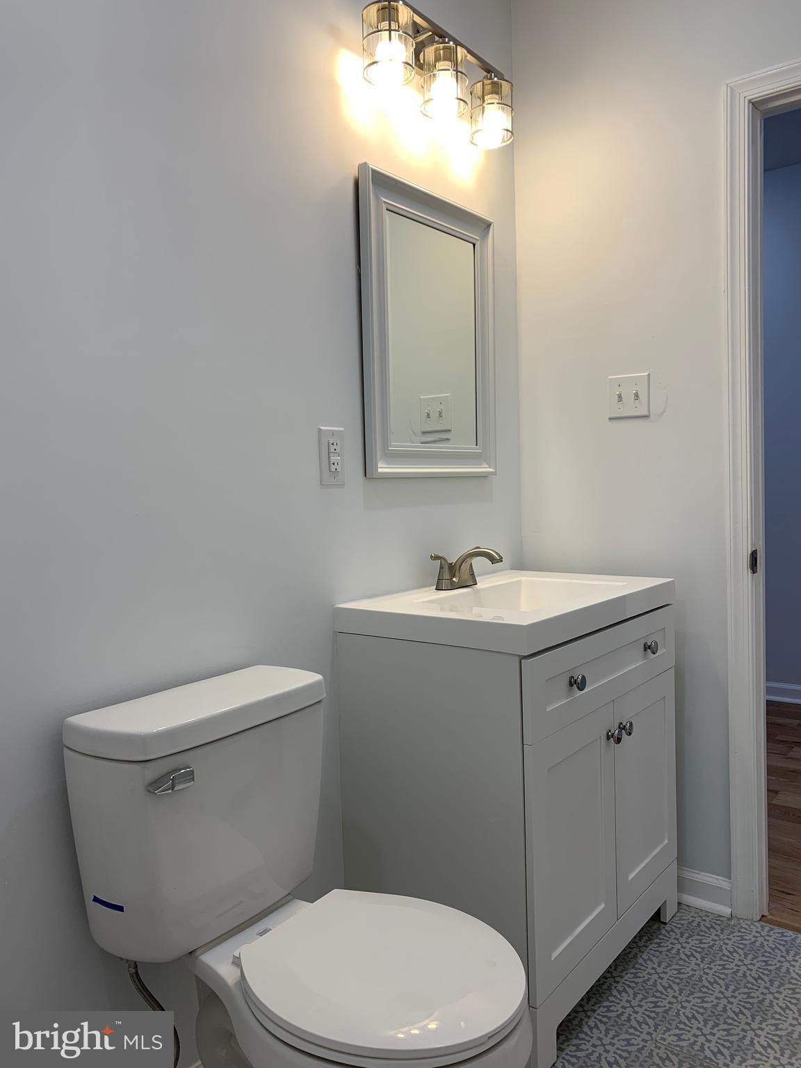 431 South 56th Street, Unit 1 Philadelphia, PA 19143 - Photo 21 of 29 a white toilet sitting next to a bathroom sink