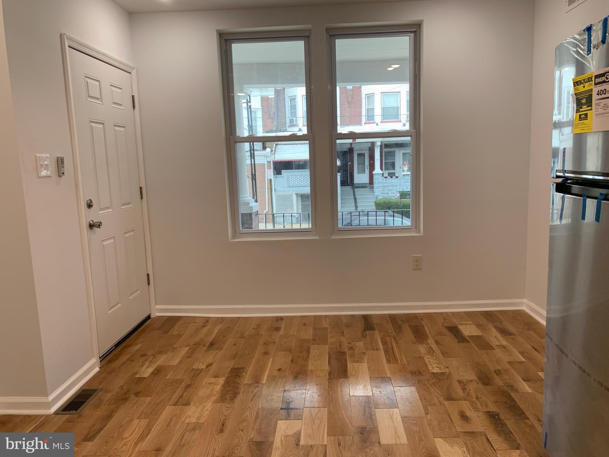 431 South 56th Street, Unit 1 Philadelphia, PA 19143 - Photo 6 of 29 a view of an empty room with wooden floor and a window