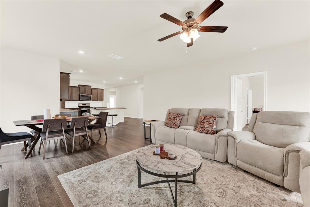 720 Willow View Way Princeton, TX 75407 - Photo 11 of 33 a living room with furniture kitchen view and a dining table