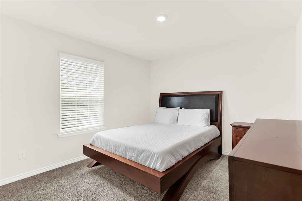 720 Willow View Way Princeton, TX 75407 - Photo 13 of 33 a bedroom with a bed and a night stand