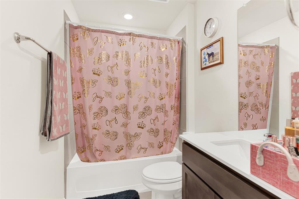 720 Willow View Way Princeton, TX 75407 - Photo 19 of 33 a bathroom with a granite countertop sink a toilet and a shower