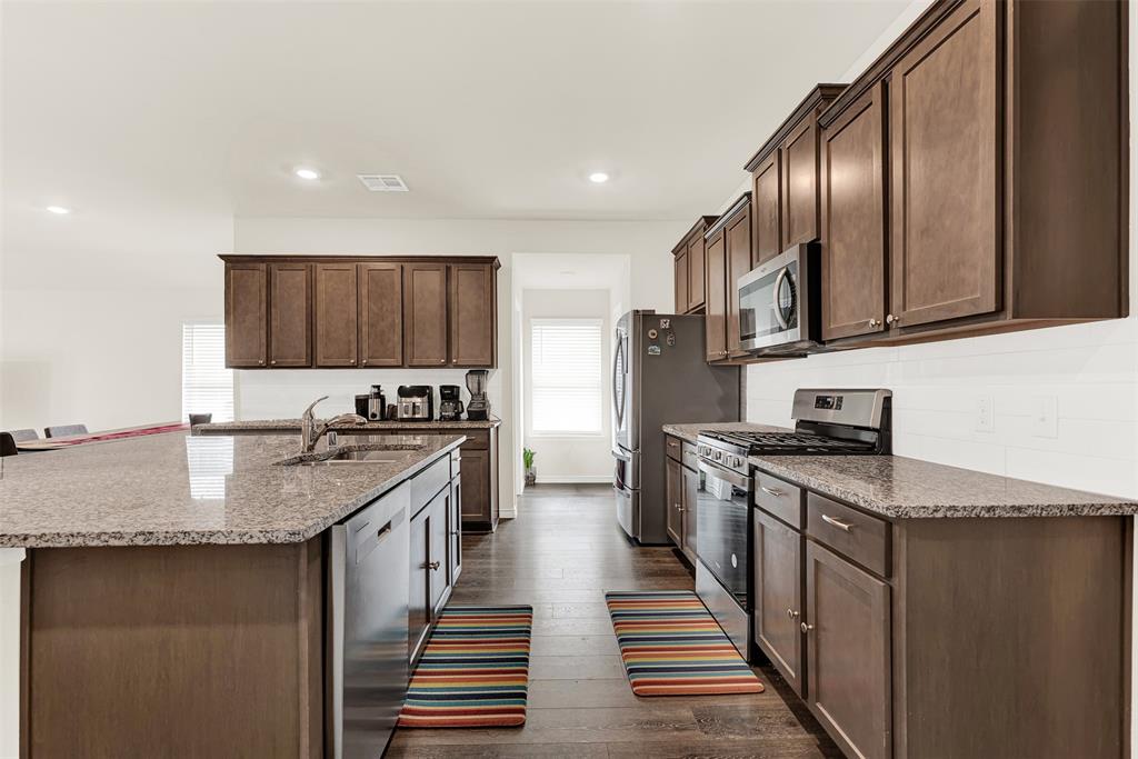 720 Willow View Way Princeton, TX 75407 - Photo 2 of 33 a kitchen with stainless steel appliances granite countertop a sink stove and refrigerator