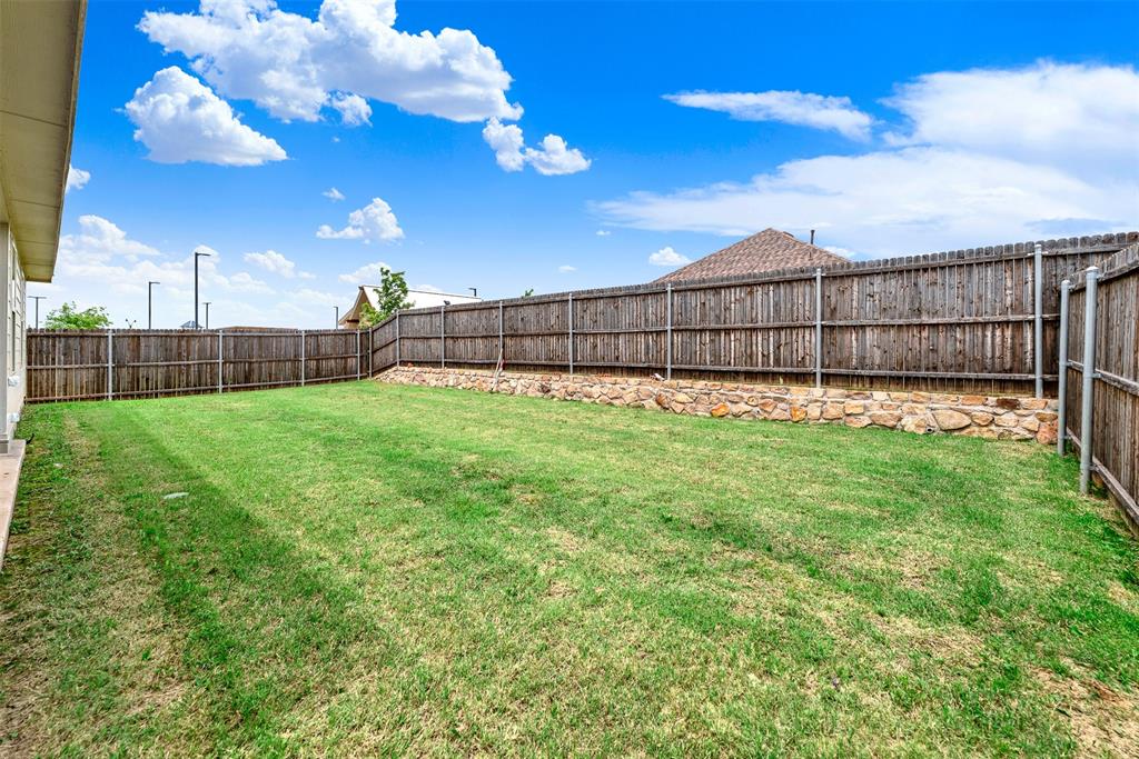 720 Willow View Way Princeton, TX 75407 - Photo 24 of 33 a view of a backyard with a fence