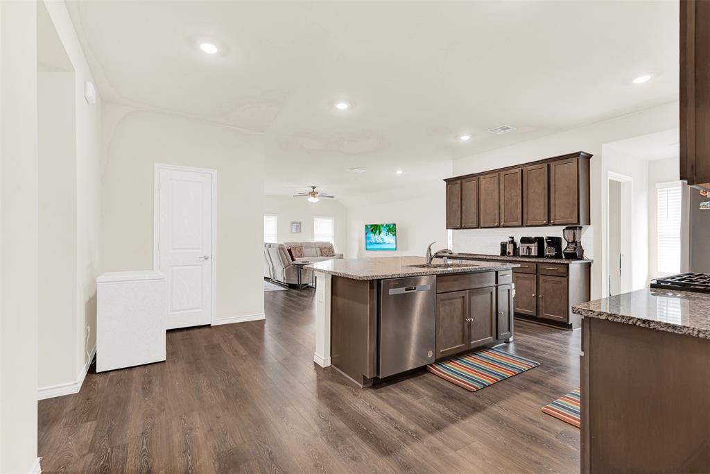 720 Willow View Way Princeton, TX 75407 - Photo 4 of 33 a kitchen with a refrigerator and a stove top oven