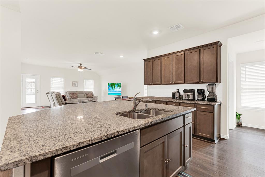 720 Willow View Way Princeton, TX 75407 - Photo 5 of 33 a kitchen with granite countertop a sink a counter space appliances and cabinets
