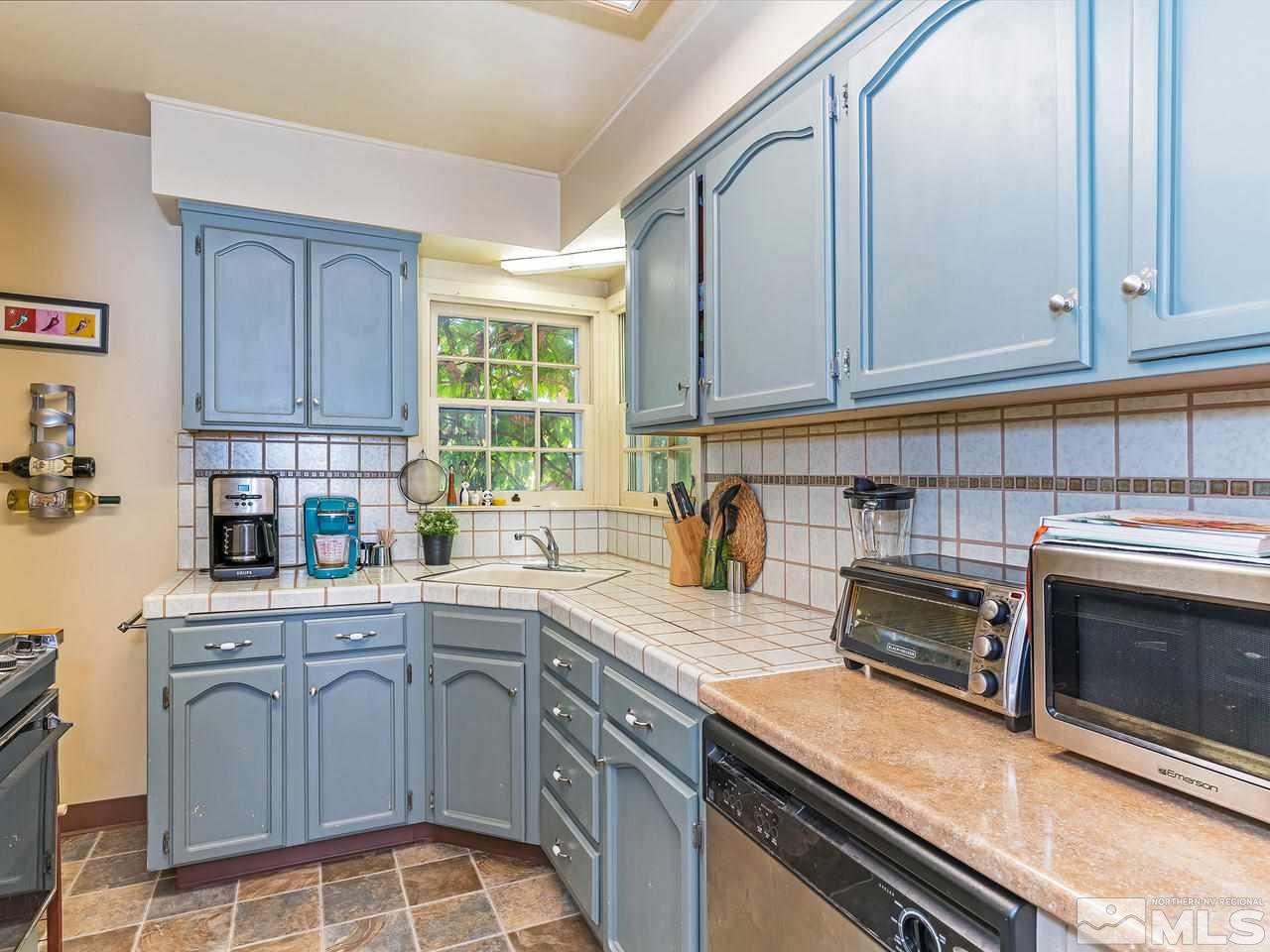 1441 Forest Street Reno, NV 89509 - Photo 7 of 15 a kitchen with stainless steel appliances granite countertop a sink stove and cabinets