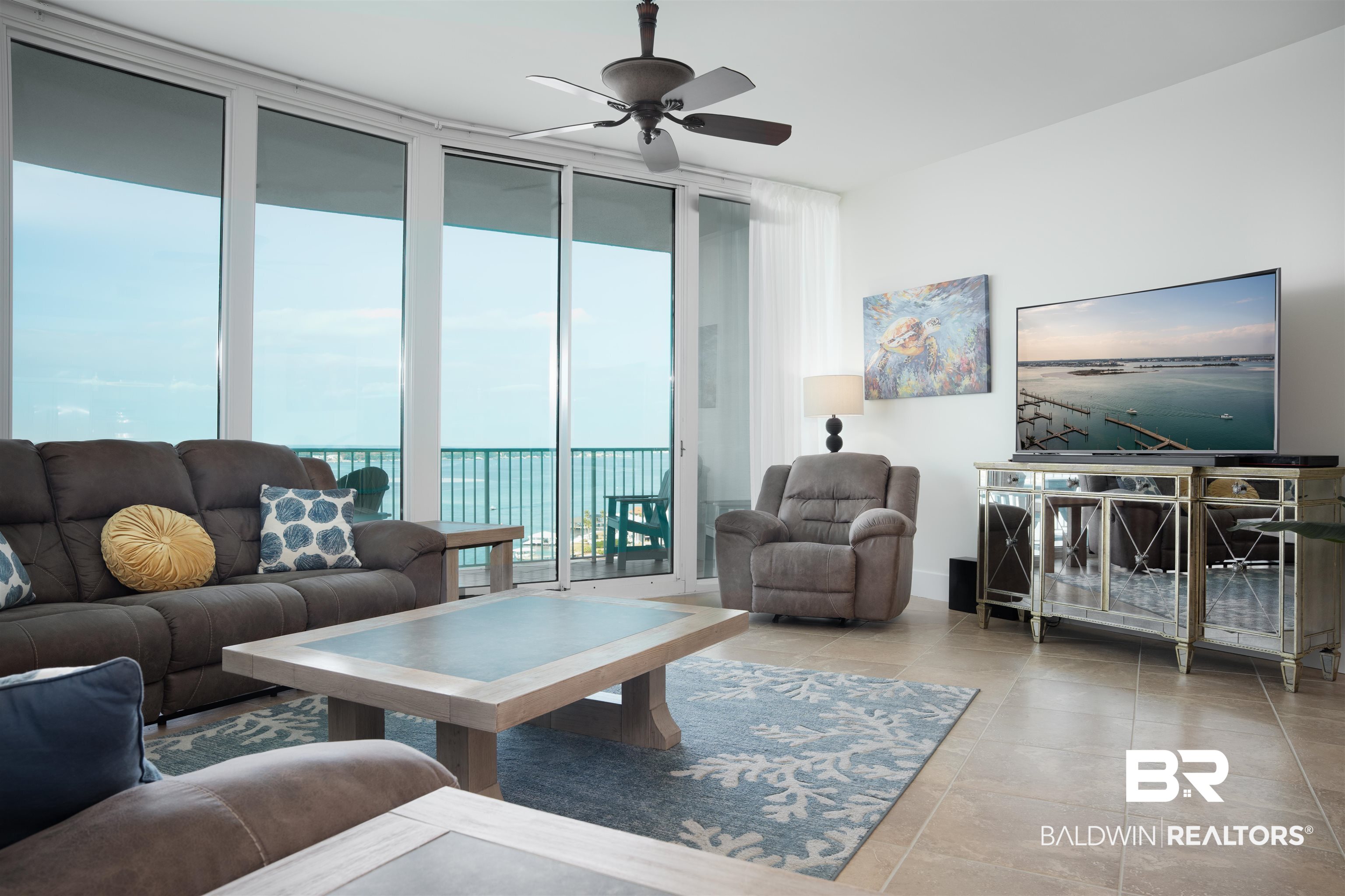 28107 Perdido Beach Boulevard, Unit DPH05 Orange Beach, AL 36561 - Photo 2 of 43 Living room with floor to ceiling windows, ceiling fan, and light tile patterned floors