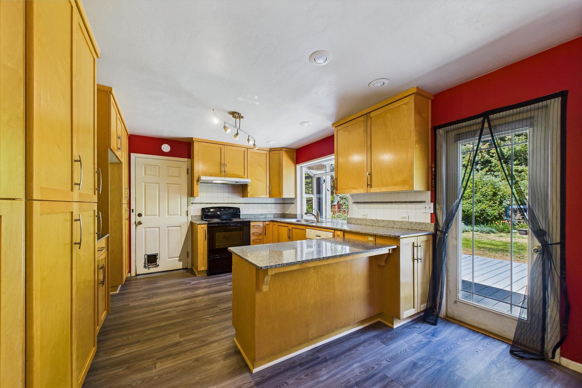 1945 Grange Road McKinleyville, CA 95519 - Photo 21 of 62 a kitchen with stainless steel appliances granite countertop a refrigerator a stove and a wooden floors