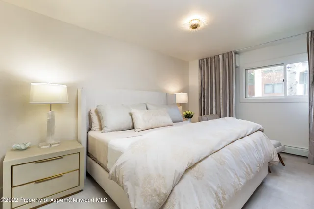 a bedroom with a bed and a night stand