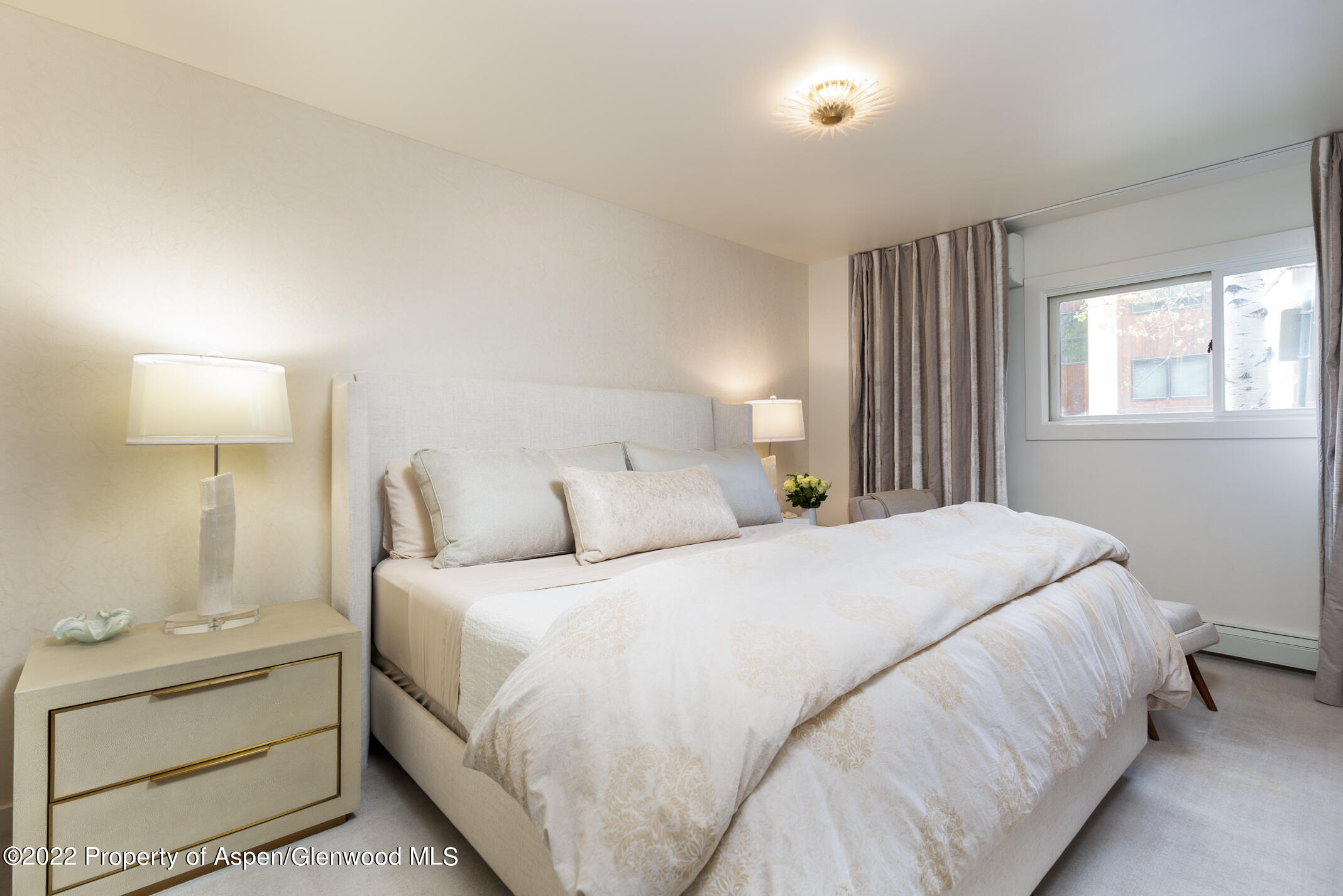 124 East Durant Avenue, Unit 2 Aspen, CO 81611 - Photo 11 of 15 a bedroom with a bed and a night stand