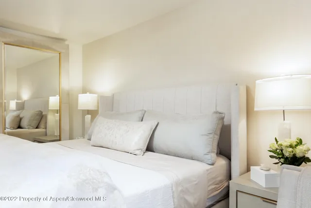 a bed room with a bed and a chair