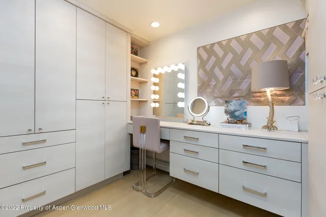 a spacious bathroom with a double vanity sink a mirror and shower