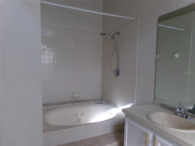 a bathroom with a granite countertop sink a toilet and shower