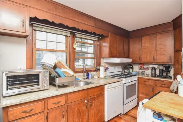 a kitchen with stainless steel appliances a stove sink and cabinets