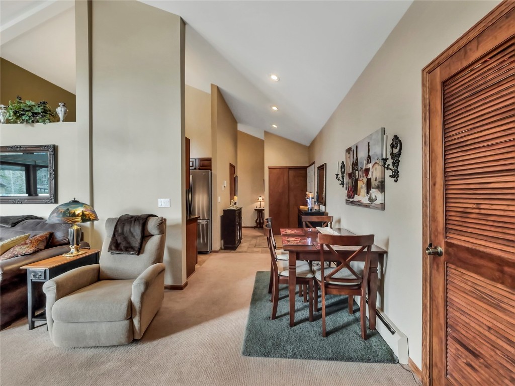 3710 Ryan Gulch Road, Unit 3710 Silverthorne, CO 80498 - Photo 13 of 50 a living room with furniture and a dining table with rug