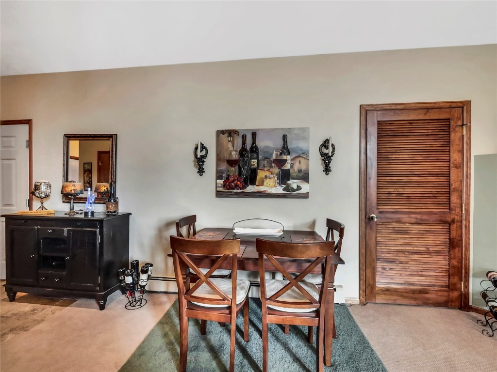 3710 Ryan Gulch Road, Unit 3710 Silverthorne, CO 80498 - Photo 14 of 50 a dining room with furniture and wooden floor